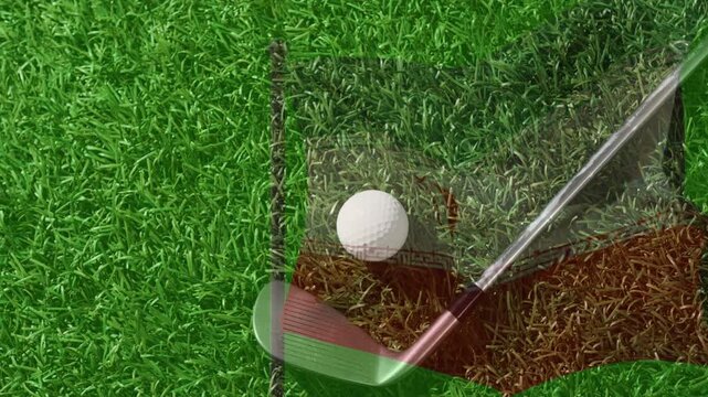 White golf ball rotating after clubhead approaching from upper right and striking ball for practice
