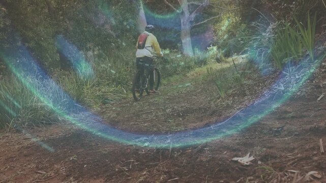 Male cyclist pedaling navigating narrow trail to sunny gap with lens flares drifting across sports