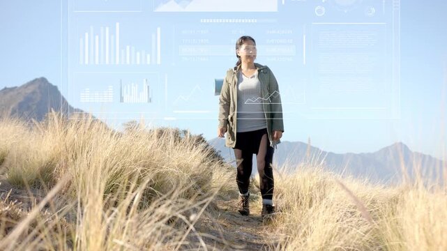 Midadult woman with pack starting hike on ridge, walking while nav HUD overlays shifting over frame