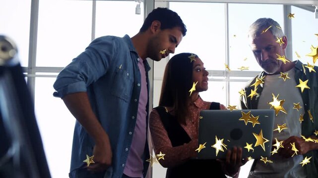 Woman raising laptop, presenting business data for review with two men, gold stars overlaying