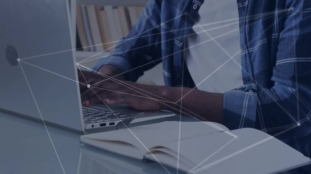 Man starting typing on laptop, animated network overlaying hands and notebook visualizing tech data