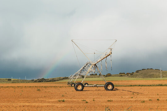 Irrigation system on rural farmland under cloudy sky