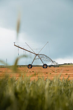Center pivot irrigation system watering dry farmland field