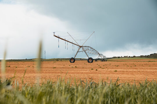 Center pivot irrigation system on dry farmland landscape