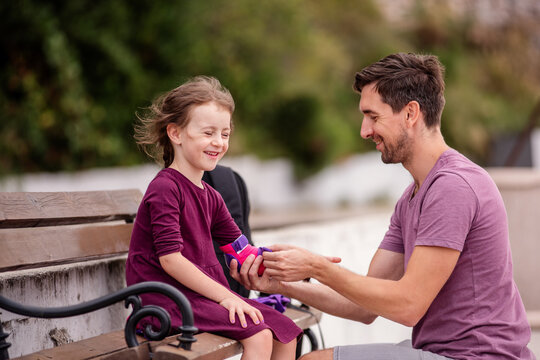 Father helping daughter with pads