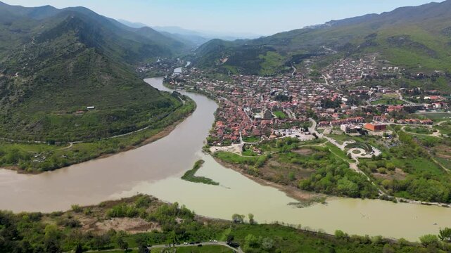 Aerial view of two rivers merging with clearly visible different water colors. Natural landscape with strong visual contrast.