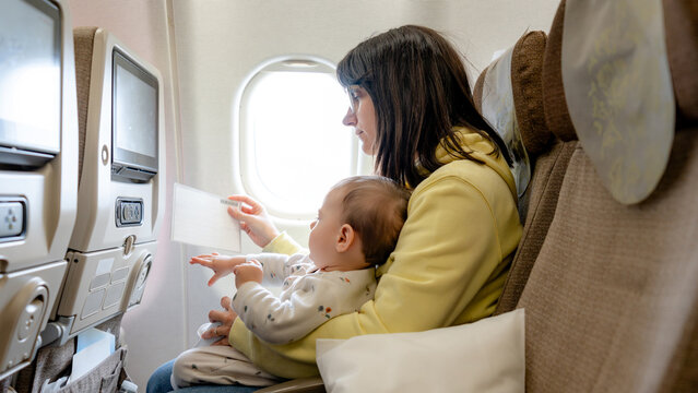 Mother and baby on airplane during family trip