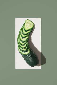 Fresh sliced cucumber spiral on minimalist background
