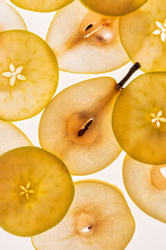 Pear and apple slice pattern on bright white background