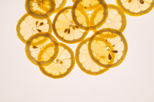 Overlapping lemon slices on white background with copy space