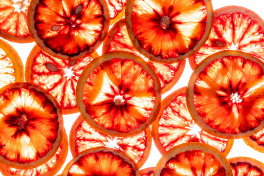 Blood orange slices on white background, vibrant citrus