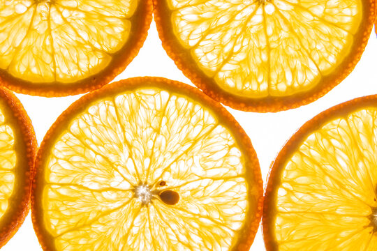 Bright orange citrus slices background with juicy texture