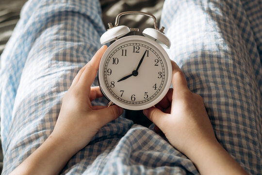 Peaceful morning in pajamas with an alarm clock