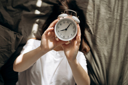 Relaxing in bed with a clock on a day off