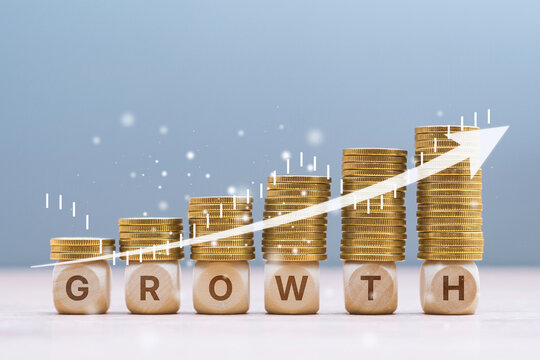 Business growth. Stacked gold coins on wooden blocks spelling growth with upward arrow. Concept financial increase and investment success. Profit expansion, savings strategy and fintech.