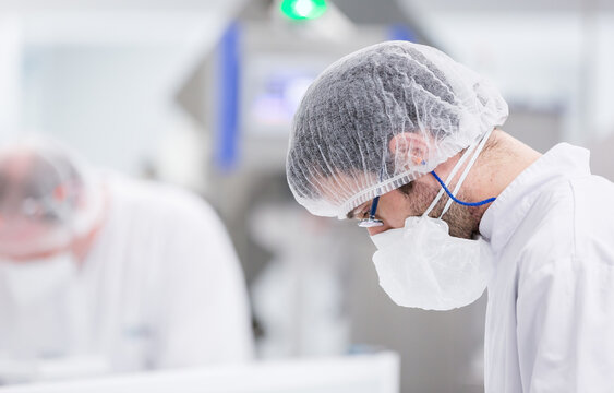 Technician in candy laboratory factory wearing protective gear