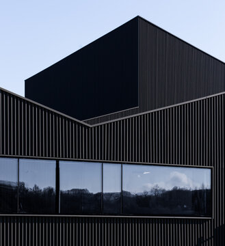 Modern candy factory exterior with dark metal facade