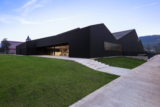 Modern candy factory exterior with black metal industrial design