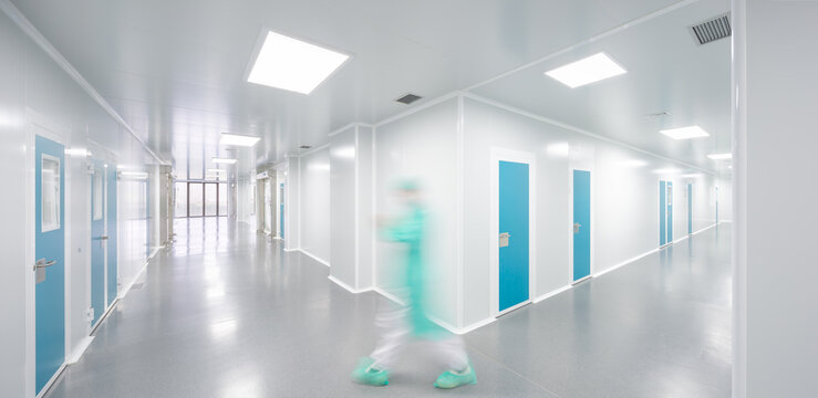 Modern candy lab factory corridor with worker in cleanroom