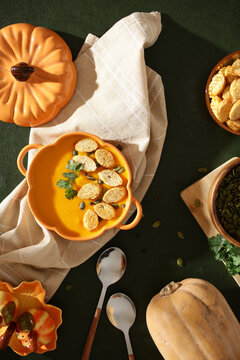 Pumpkin soup with croutons and fresh herbs served