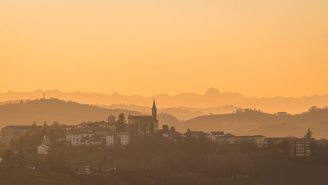 Sunset over Piemonte hills and village skyline, Italy
