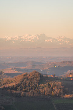 Sunset over Piemonte hills with snowy Alps in Italy