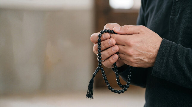 Prayer beads held in hands symbolizing meditation and mindfulness practice. Each bead represents a moment of reflection and thoughtfulness during personal rituals.