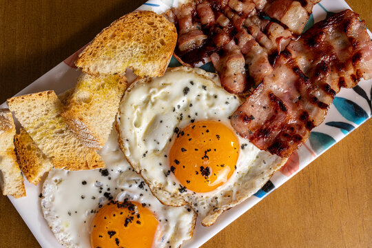 Hearty breakfast plate with fried egg, bacon and bread