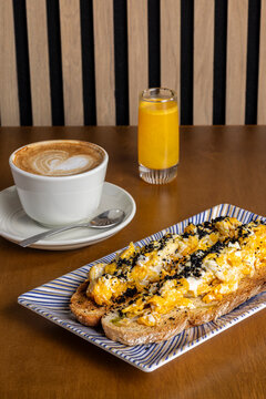 Morning breakfast with cappuccino, juice and egg toast