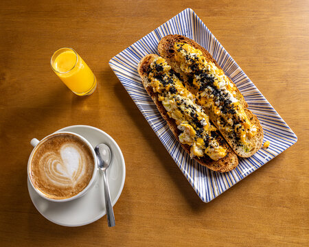Morning breakfast with cappuccino, juice and egg toast