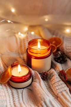 Cozy soy candle in amber jar with warm autumn decor