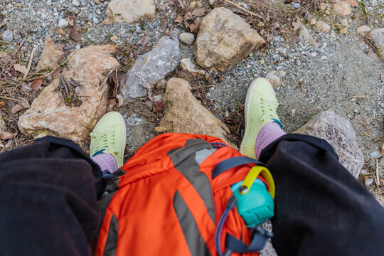 Hiker view with backpack on rocky mountain trail