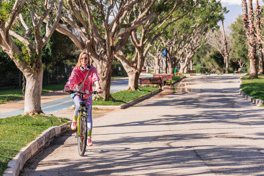Woman enjoying a bicycle ride in a sunny park