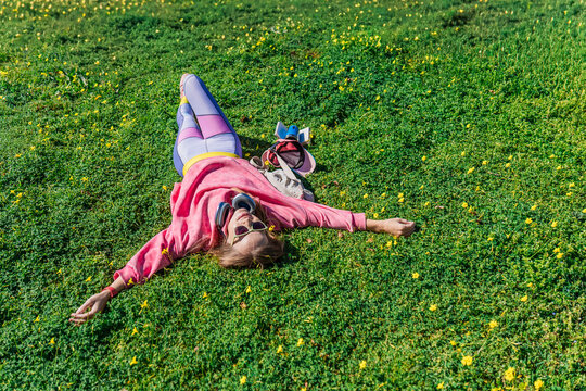 Woman relaxing on grass in sunny park day