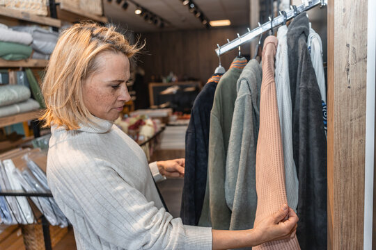 Woman exploring textile offerings in trendy store
