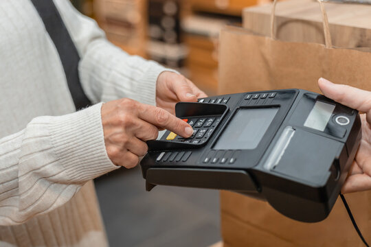 Customer making payment in a textile store setting