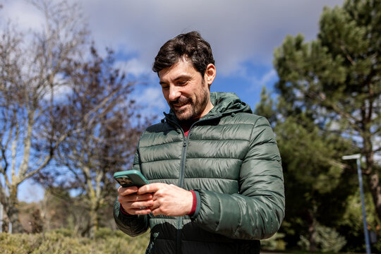 Man enjoying a fun moment on his phone outdoors