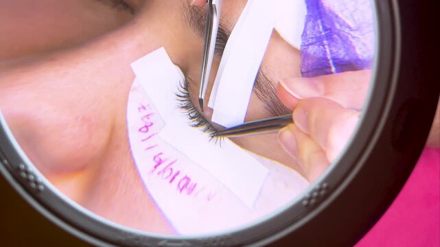 Professional eyelash extension procedure in a beauty salon.