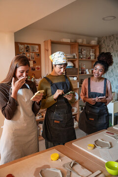 Friends share ideas in a pottery workshop studio setting