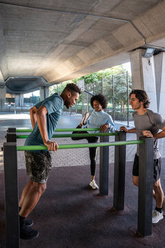 Outdoor calisthenics workout with friends at street gym
