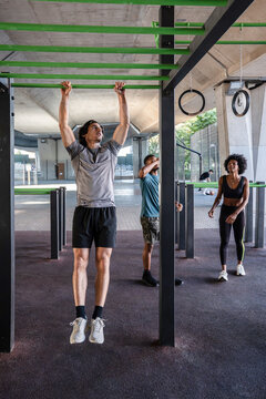 Outdoor gym group doing pull up and fitness training