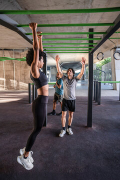 Outdoor calisthenics class training on monkey bars