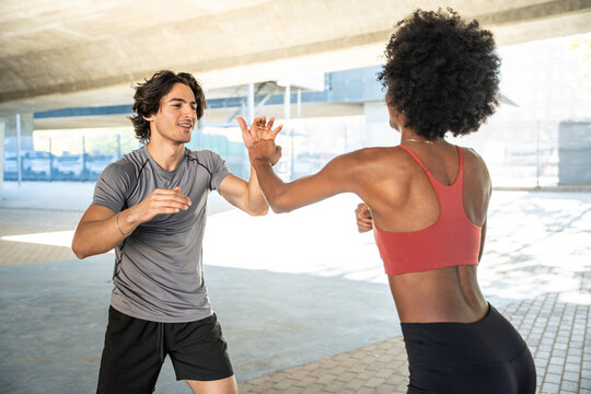 Outdoor fitness partners practicing self defense drill