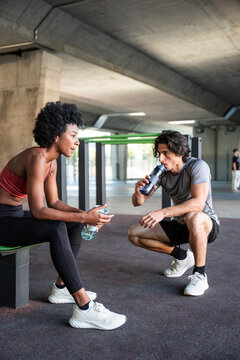 Athletes resting and hydrating after an intense workout
