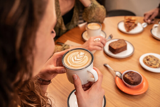 Cozy cafe moment with latte art and dessert on table
