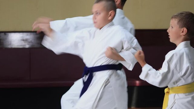 Athletes in karate perform a hand strike in motion