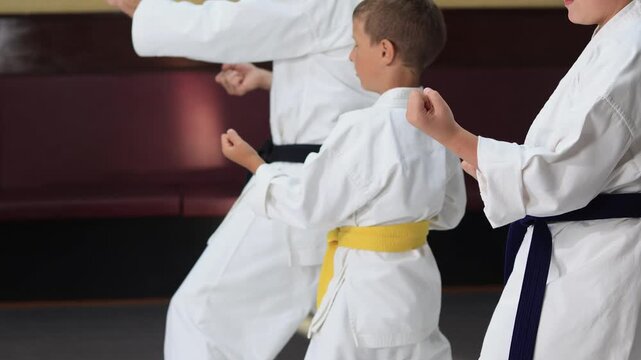A moving punch is performed by three karateka athletes