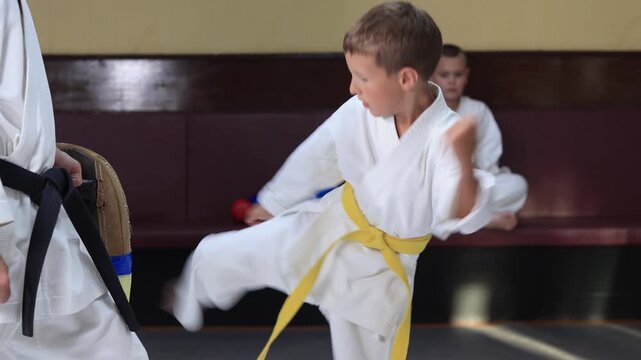 A little athlete kicks a machine