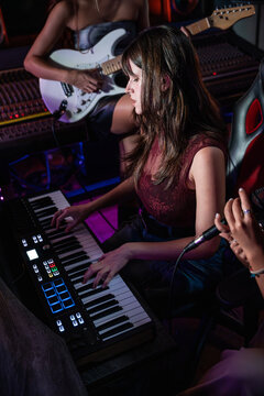 Young musician recording a song in a modern music studio