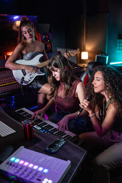 Music production session with women in a home studio